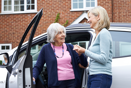 female neighbor giving senior woman car ride