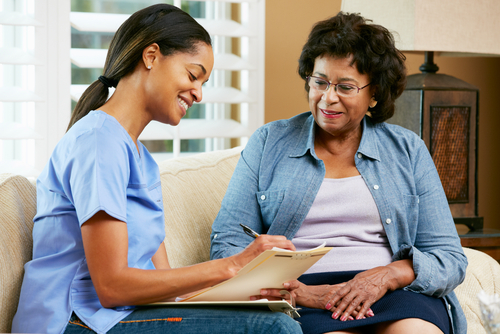 nurse writing notes home visit