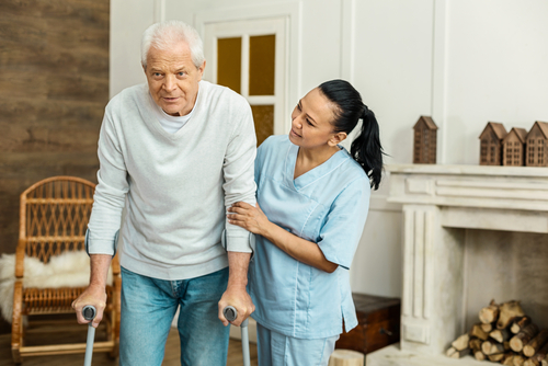 caregiver helping senior man